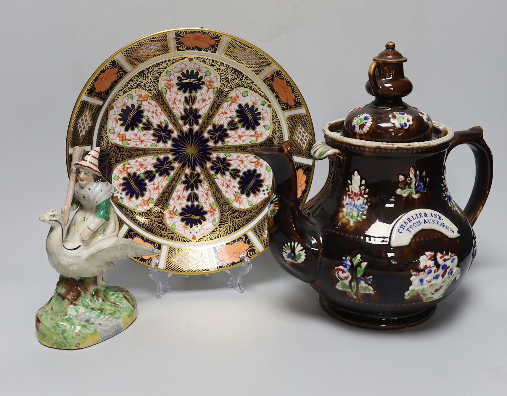 A Measham Bargeware teapot, a Derby Imari 1128 dish and an unusual Victorian Staffordshire group of a witch riding a goose, tallest 27cm